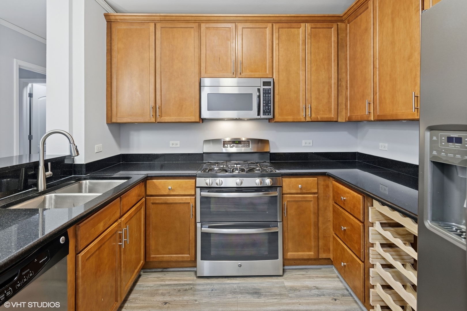 450 East Waterside Drive, Unit 505 Chicago, IL 60601 - Photo 14 of 32 a kitchen with stainless steel appliances granite countertop a sink stove and cabinets