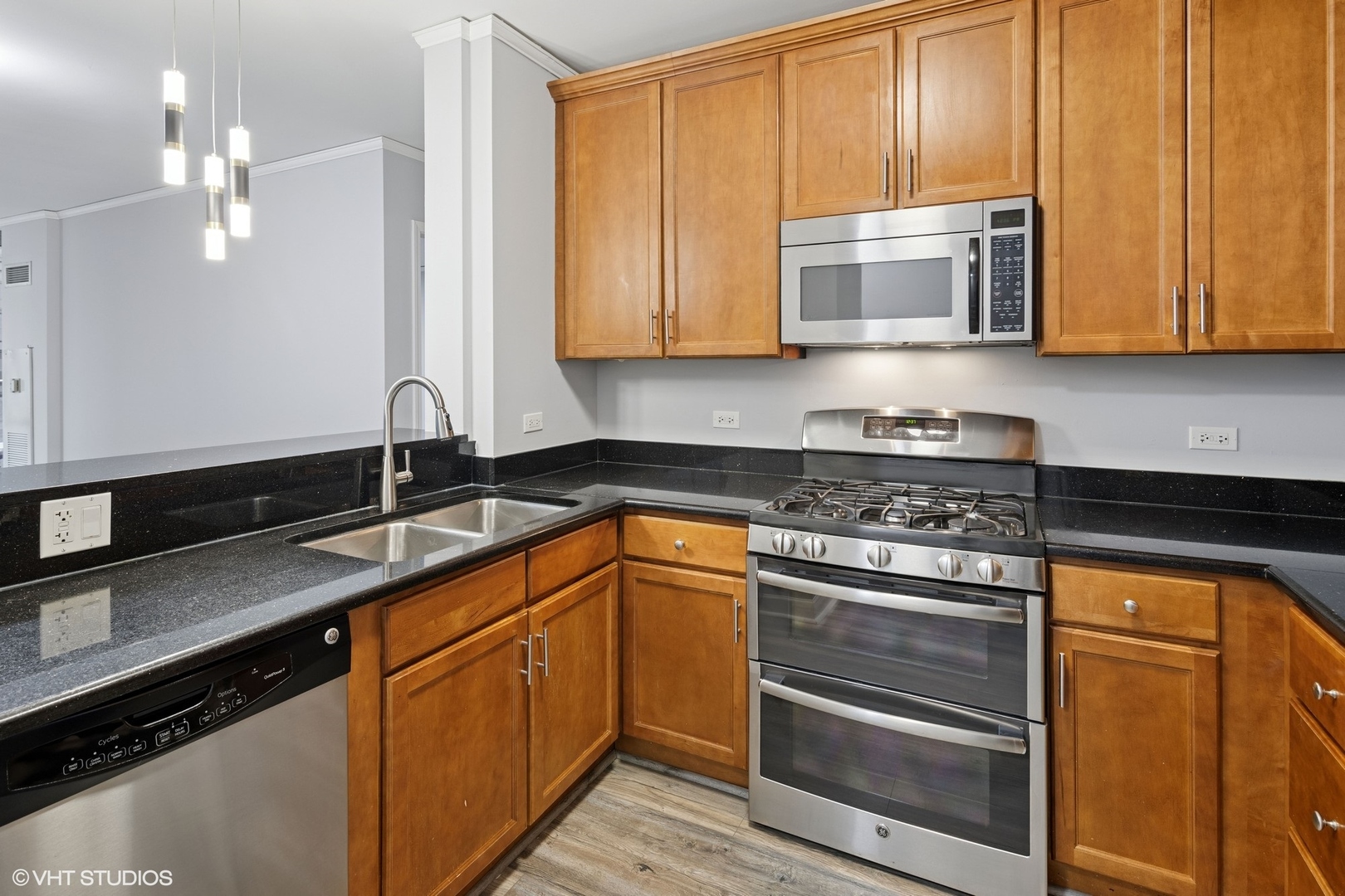 450 East Waterside Drive, Unit 505 Chicago, IL 60601 - Photo 15 of 32 a kitchen with stainless steel appliances granite countertop a sink stove and microwave