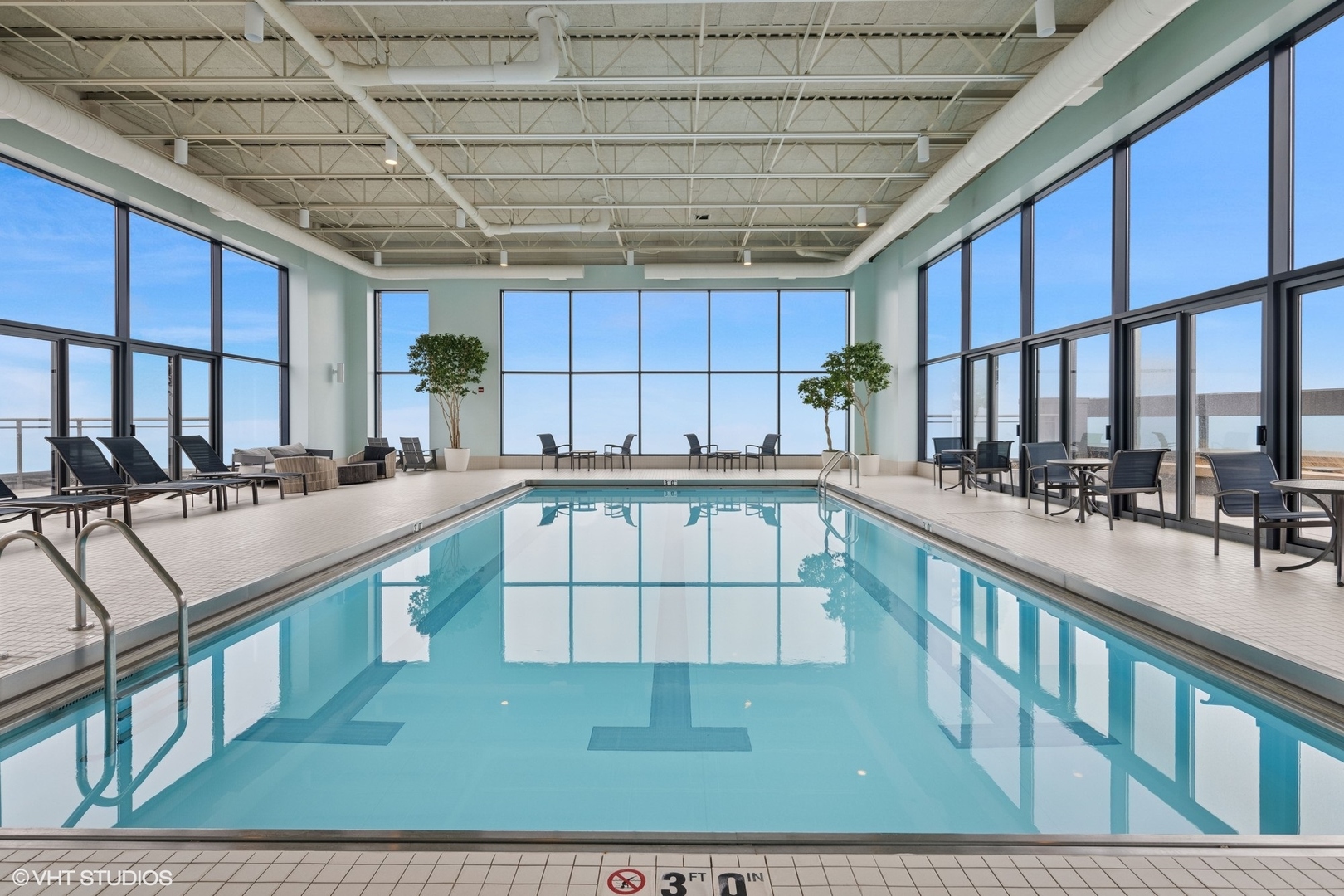 450 East Waterside Drive, Unit 505 Chicago, IL 60601 - Photo 25 of 32 a large white kitchen with kitchen island granite countertop a large window