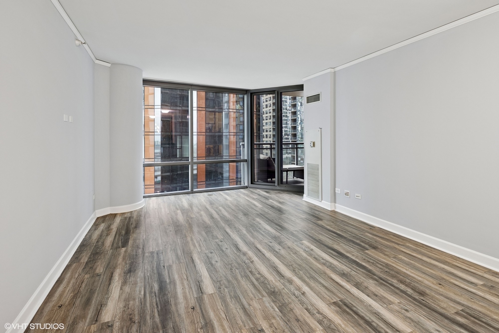 450 East Waterside Drive, Unit 505 Chicago, IL 60601 - Photo 5 of 32 wooden floor in an empty room with a window