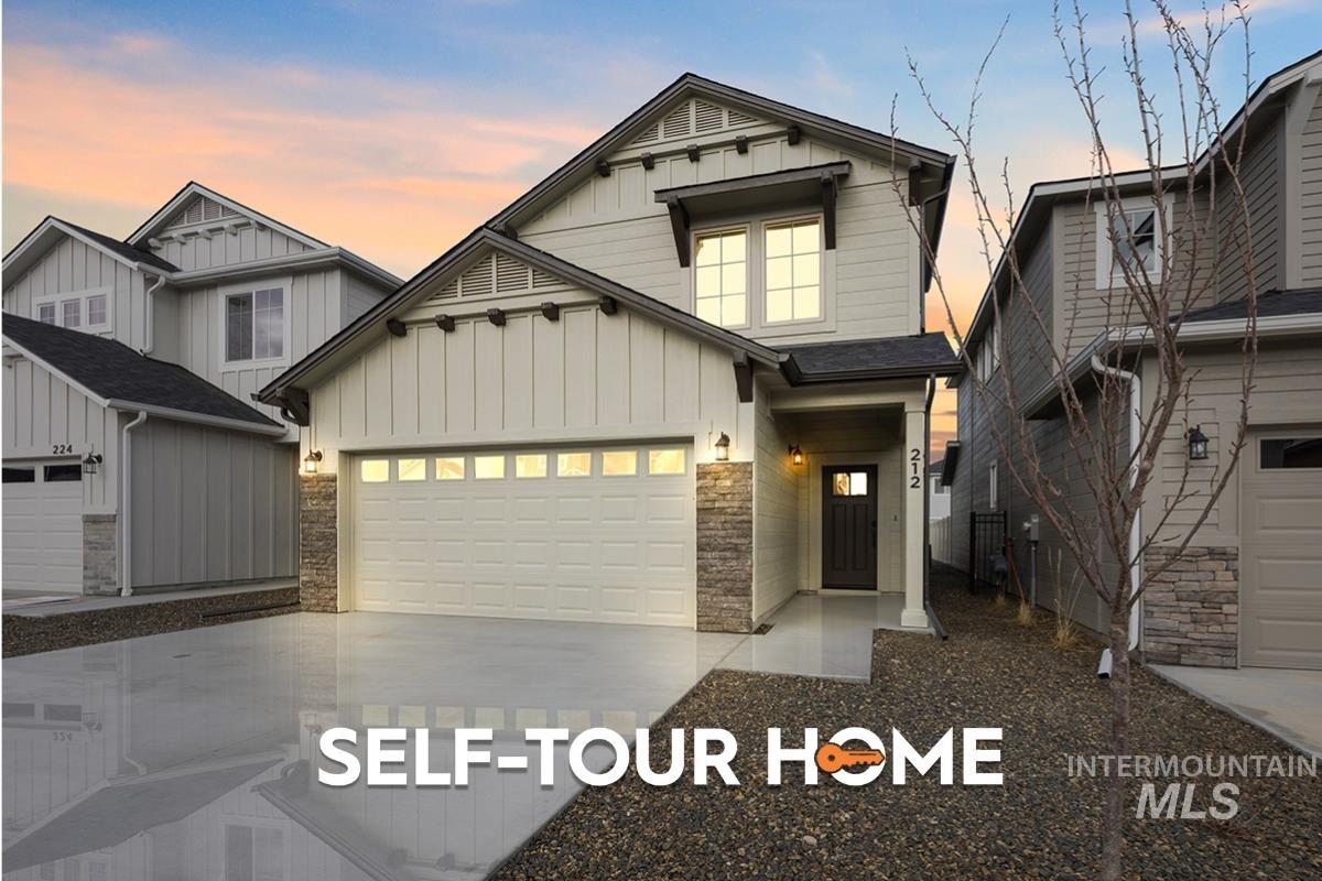 Craftsman-style home with board and batten siding, concrete driveway, stone siding, and an attached garage