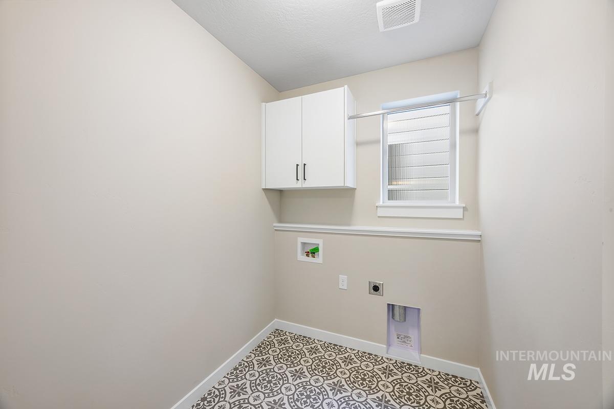 212 West Broyhill Street Meridian, ID 83642 - Photo 10 of 22 Laundry area with cabinet space, hookup for an electric dryer, and washer hookup