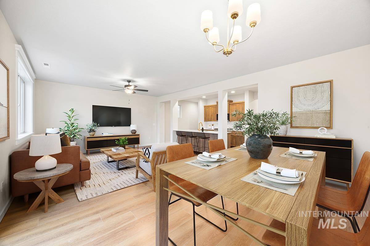 212 West Broyhill Street Meridian, ID 83642 - Photo 7 of 22 Dining area featuring light wood finished floors, a ceiling fan, and hanging lights