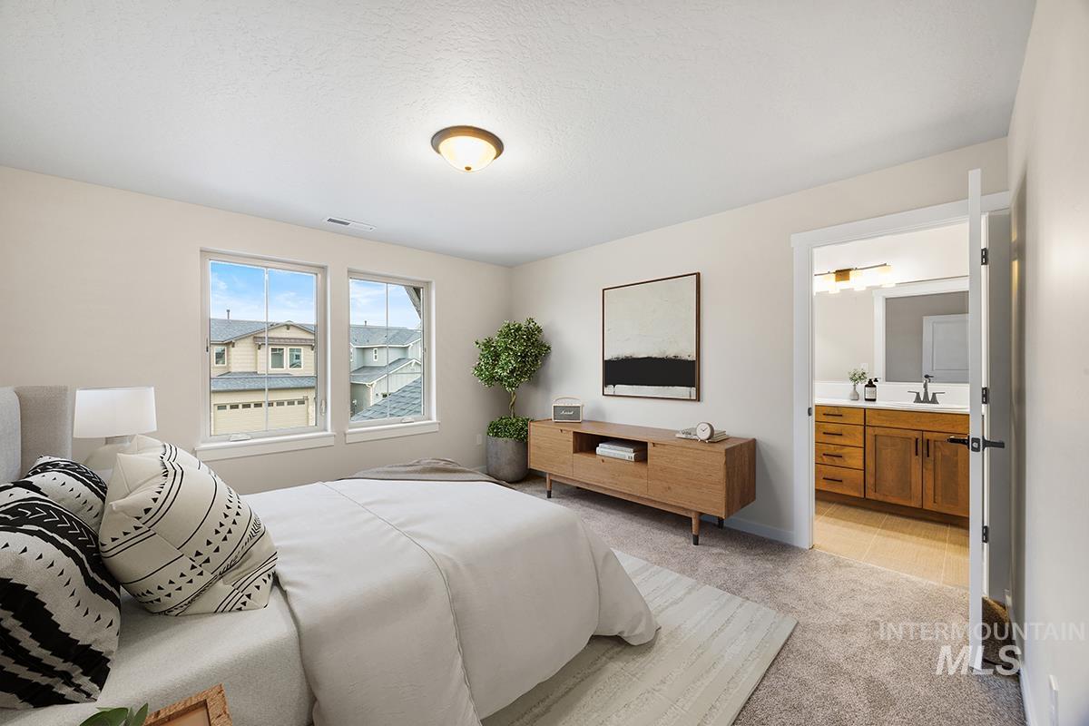 212 West Broyhill Street Meridian, ID 83642 - Photo 8 of 22 Bedroom featuring light colored carpet and ensuite bathroom