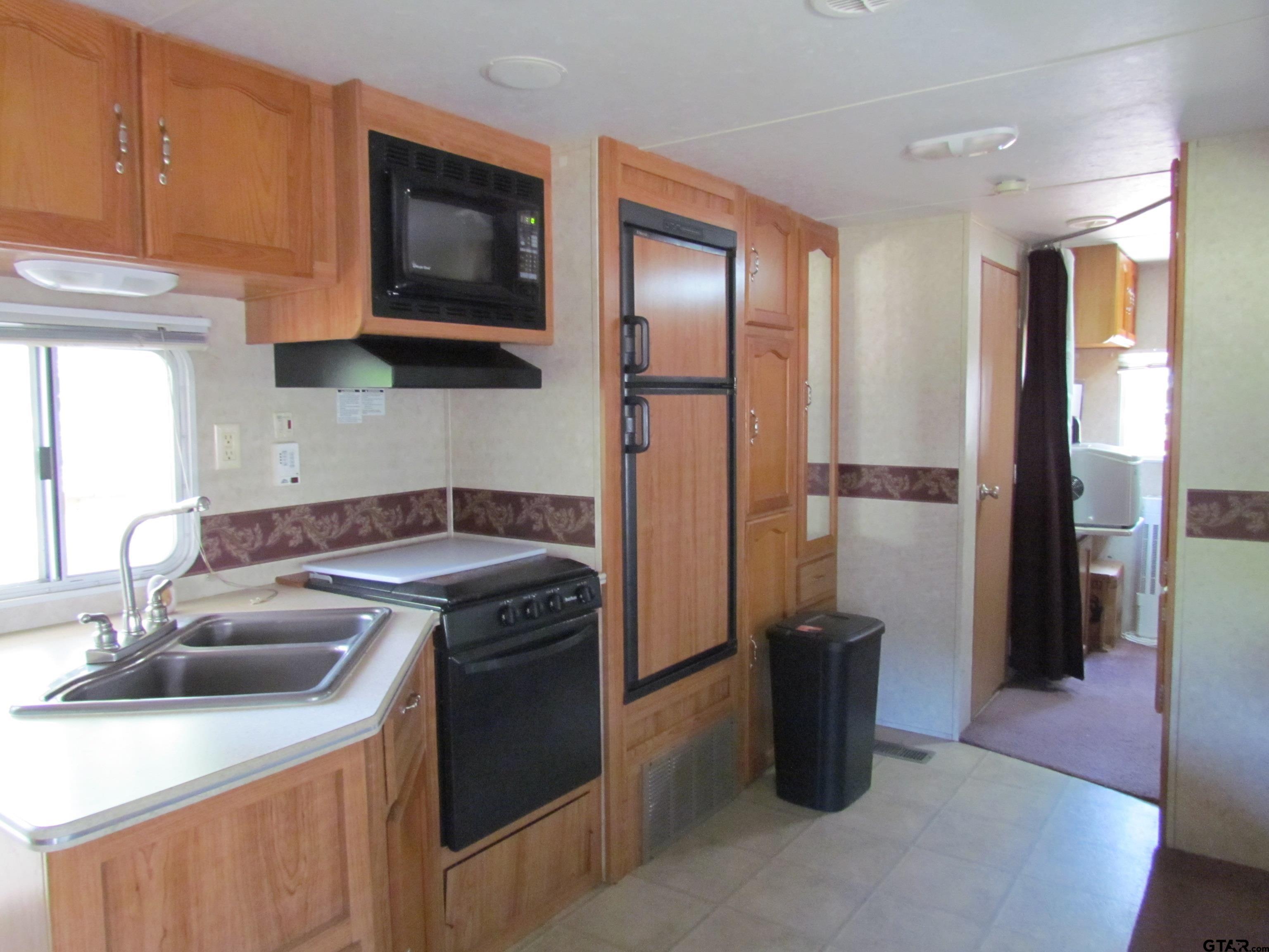 5800 Yantis Tx 75497 Yantis, TX 75497 - Photo 11 of 16 a kitchen with a sink a stove and a refrigerator