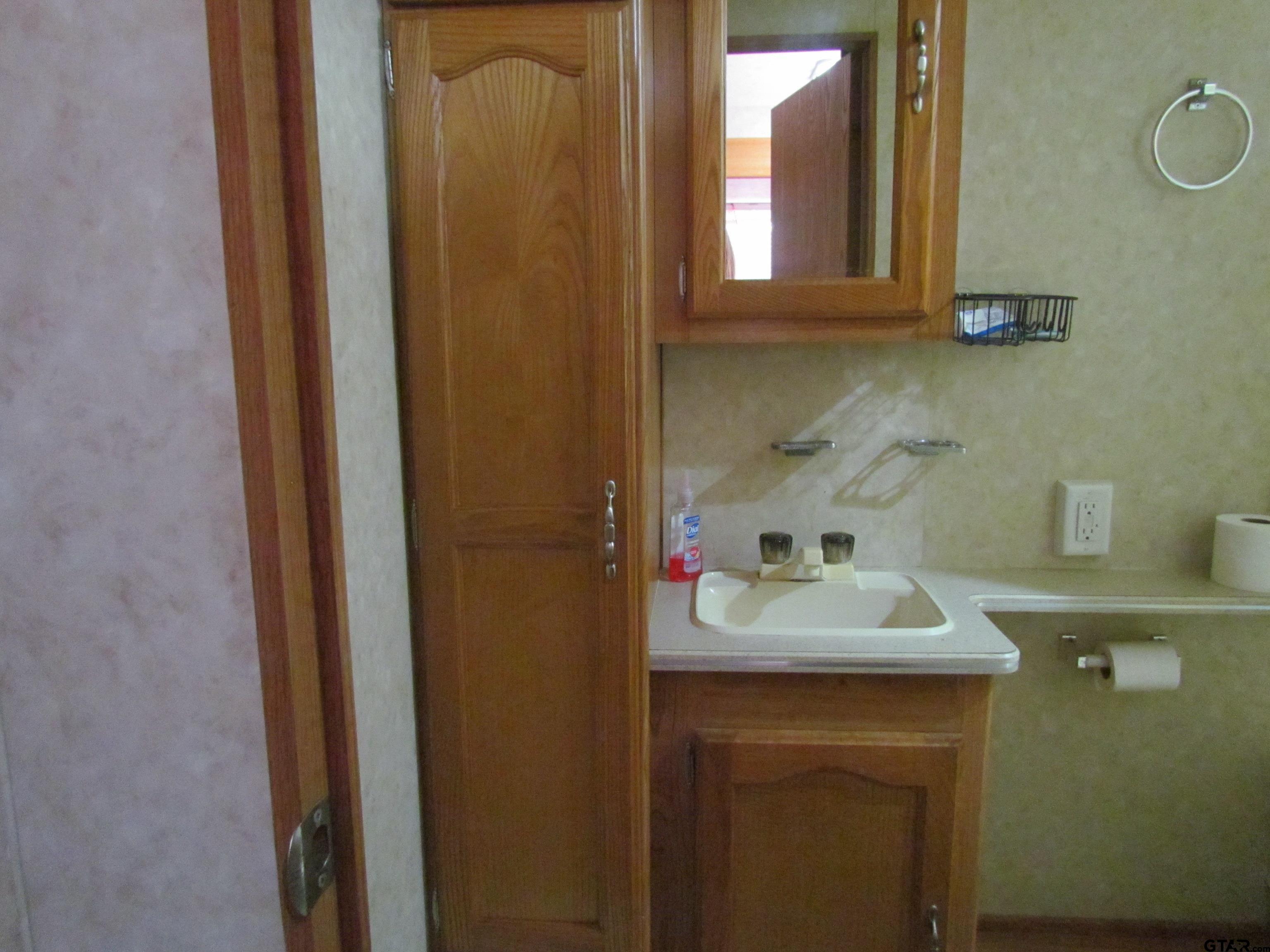 5800 Yantis Tx 75497 Yantis, TX 75497 - Photo 9 of 16 a bathroom with a sink and a mirror