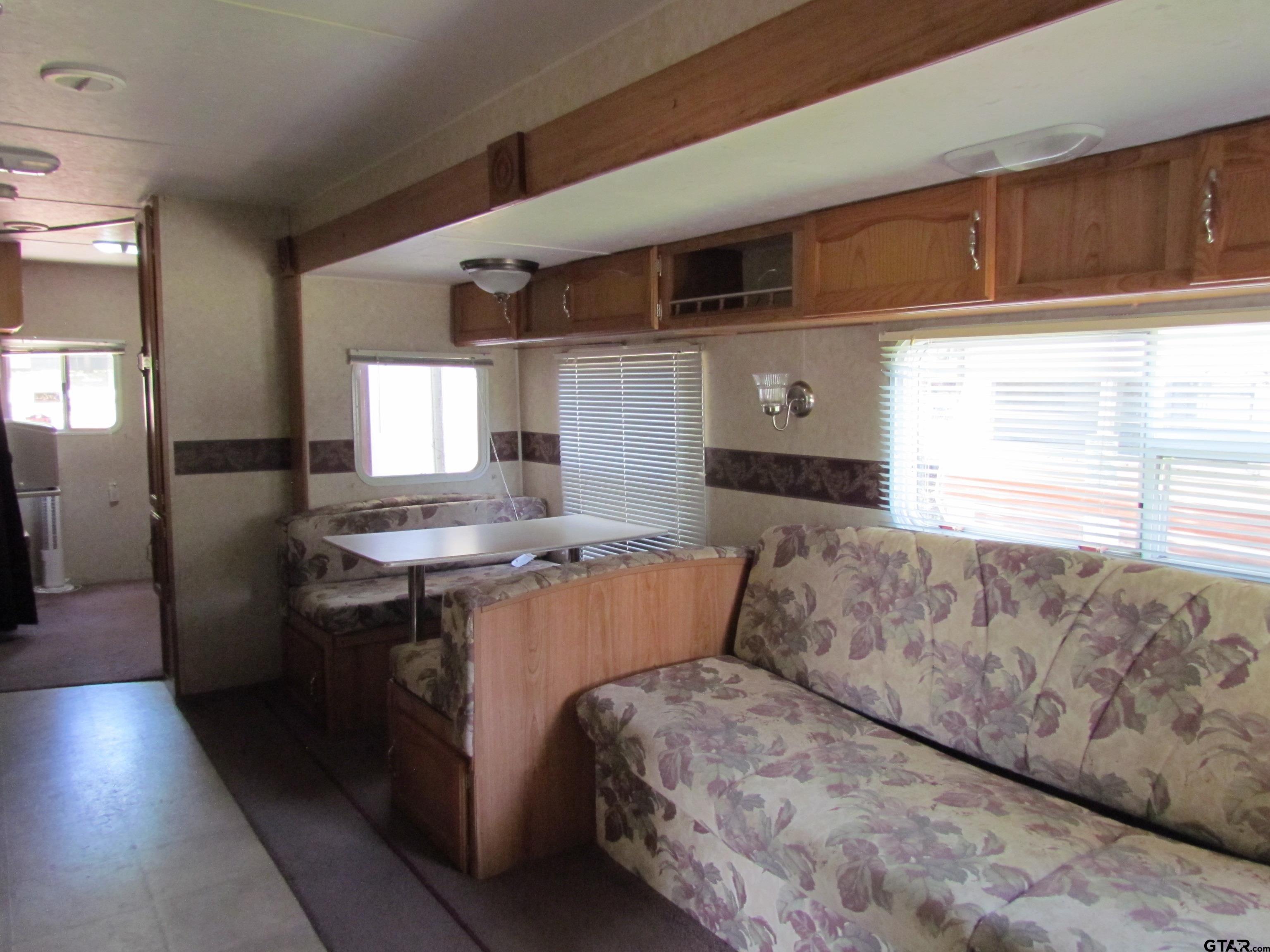 5800 Yantis Tx 75497 Yantis, TX 75497 - Photo 10 of 16 a living room with a couch and a stove top oven