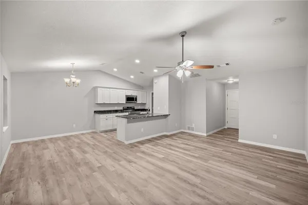 a view of kitchen with sink and wooden floor