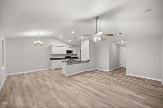 a view of kitchen with sink and wooden floor