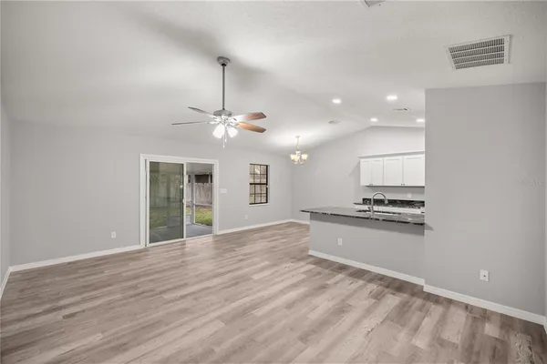 a view of a kitchen with a stove cabinets and wooden floor