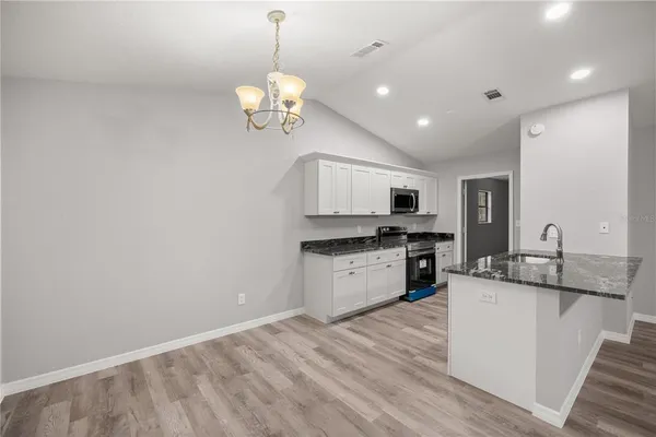 a kitchen with a stove a sink and a refrigerator