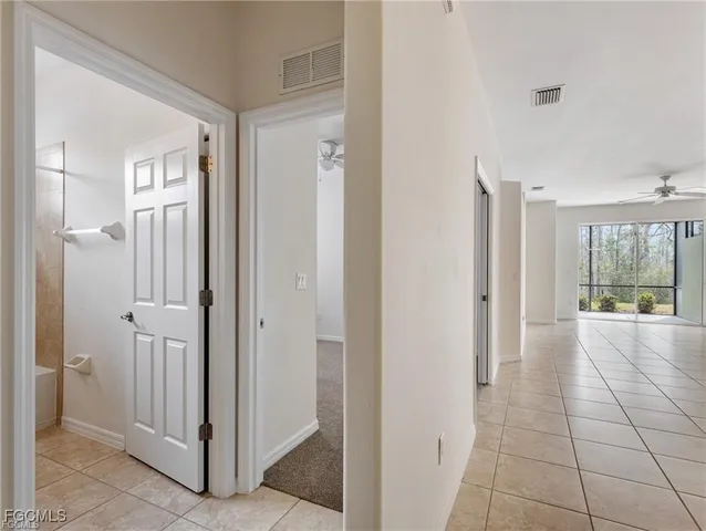 a view of a hallway with wooden shelves