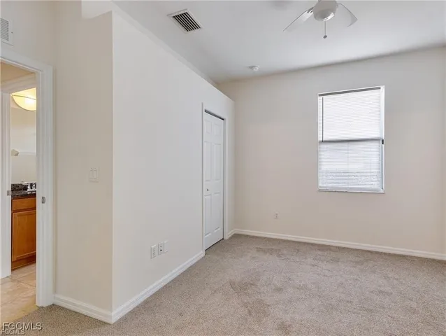 an empty room with windows and closet