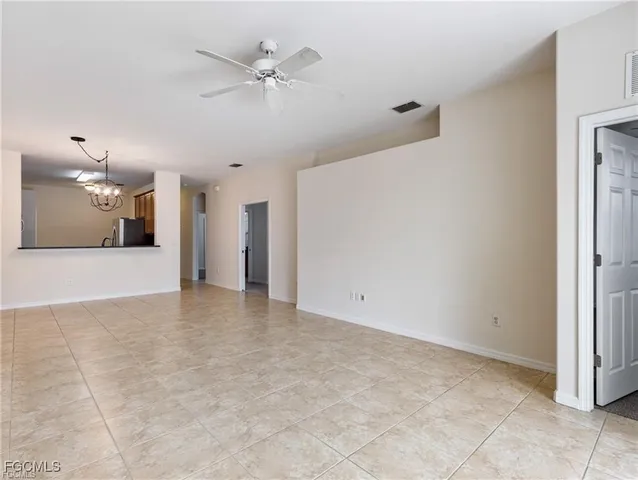 a view of a livingroom with a ceiling fan and a kitchen