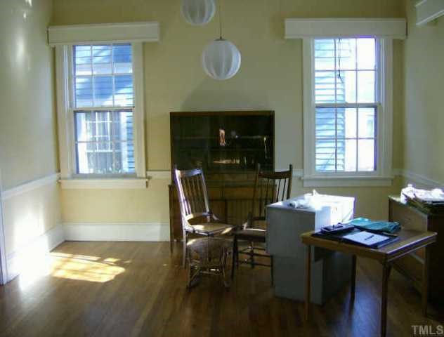 205 Forest Raleigh Nc 27605 Raleigh, NC 27605 - Photo 3 of 4 a kitchen with a table chairs and a stove