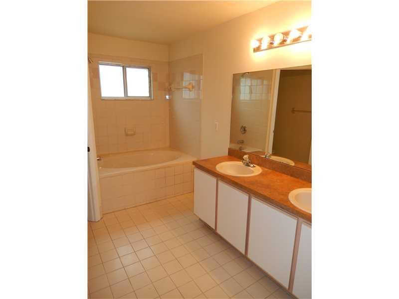 10323 Southwest 24th Street Miramar, FL 33025 - Photo 15 of 21 a bathroom with a granite countertop sink a mirror and a bathtub