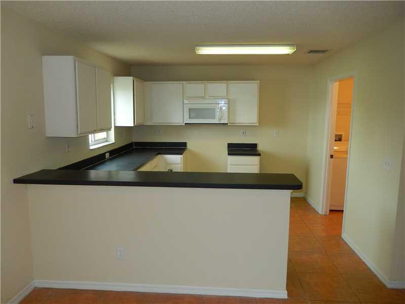10323 Southwest 24th Street Miramar, FL 33025 - Photo 4 of 21 a kitchen with granite countertop a sink stainless steel appliances and cabinets