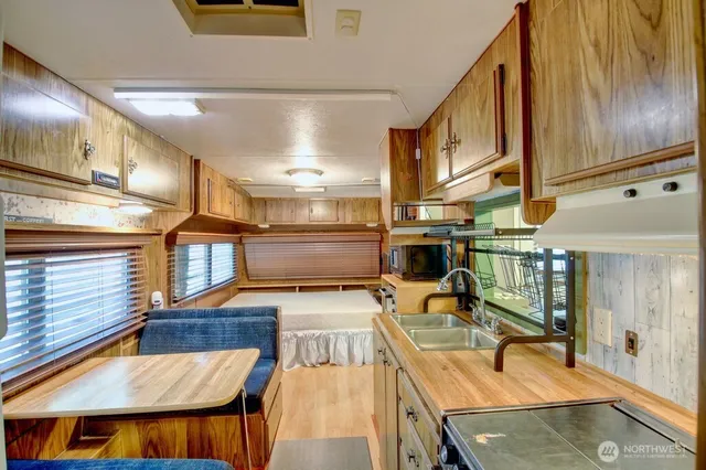 a kitchen with stainless steel appliances granite countertop a sink and a stove