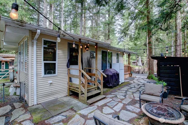 a view of a patio with couple of chairs and a fire pit