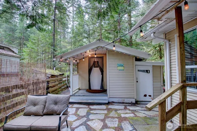 a view of backyard with outdoor seating and stairs