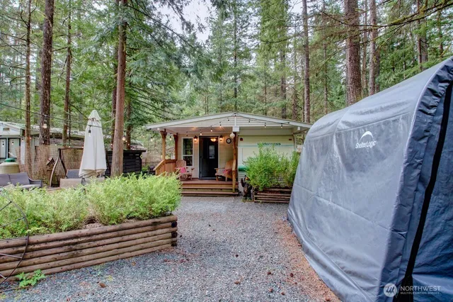 a view of a house with backyard and sitting area