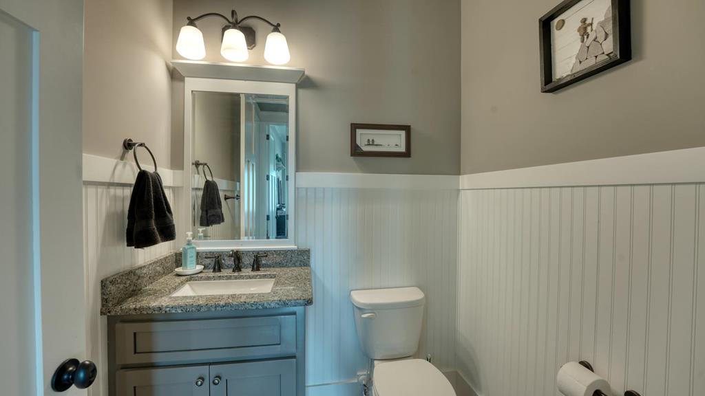 31 Elf School Road Hayesville, NC 28904 - Photo 33 of 59 a bathroom with a granite countertop sink vanity mirror and toilet
