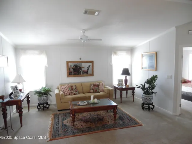 a livingroom with lounge chair and a window
