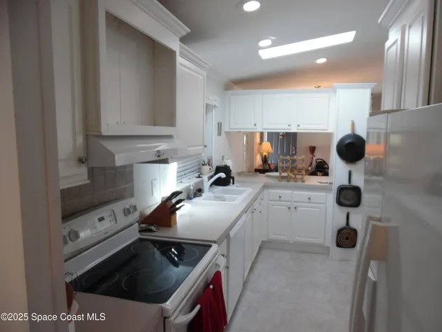 a kitchen with refrigerator and mirror
