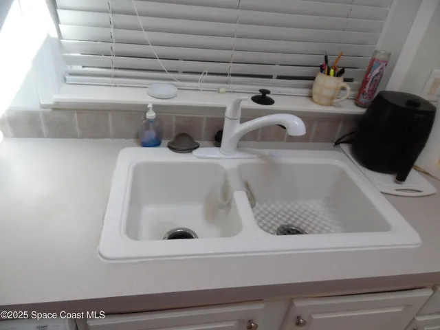 a kitchen with a refrigerator and cabinets