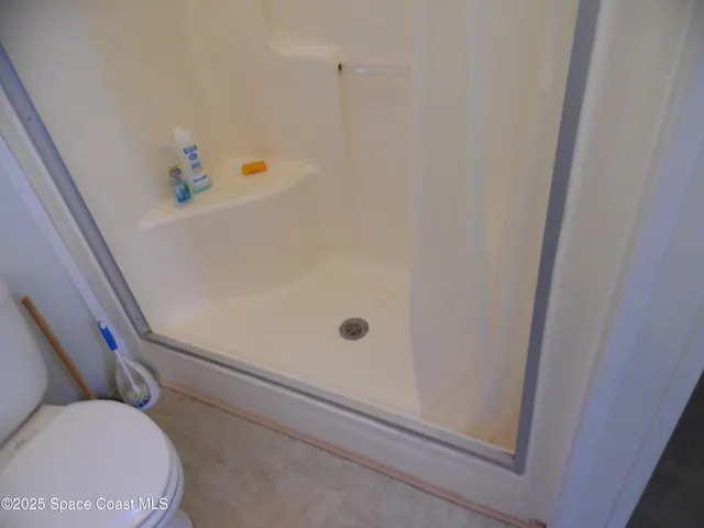 a bathroom with a refrigerator and a sink