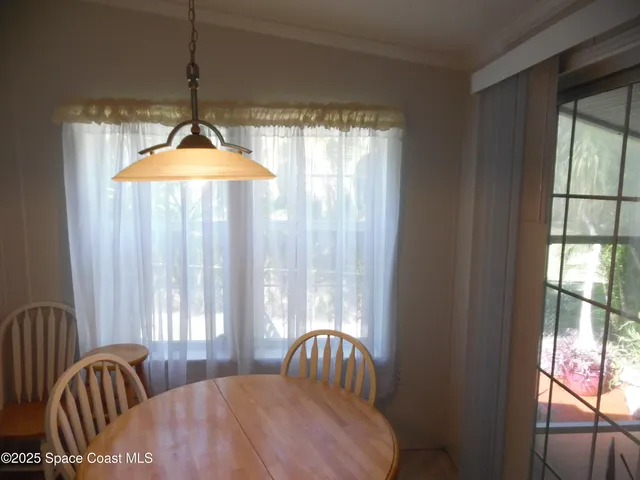 a dining room with a table and chairs
