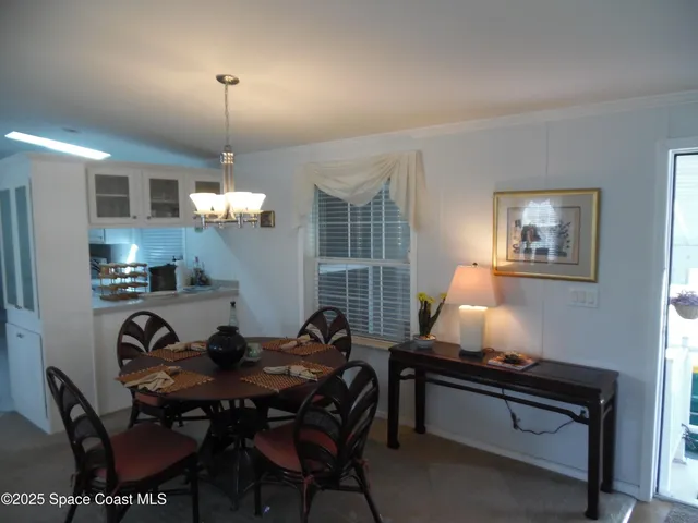a view of a dining room with furniture and window