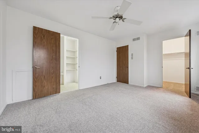 a view of an empty room with a ceiling fan