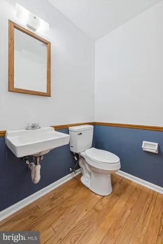 a bathroom with a sink toilet and mirror