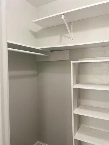 a view of an empty walk in closet