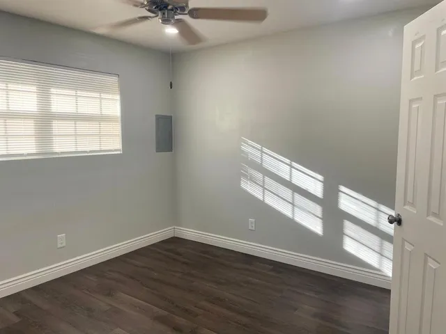 wooden floor in an empty room with a window