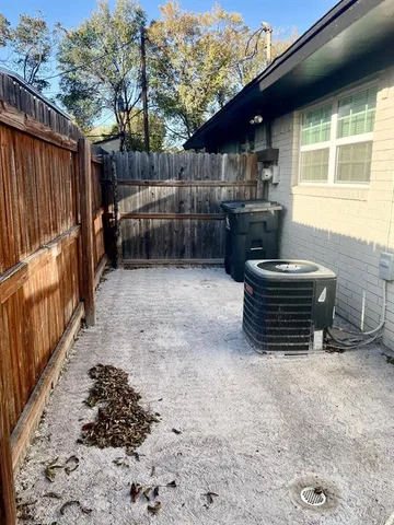 a view of a backyard with table and chairs and a large tree