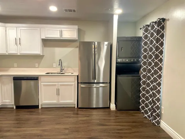 a kitchen with stainless steel appliances a refrigerator and a sink