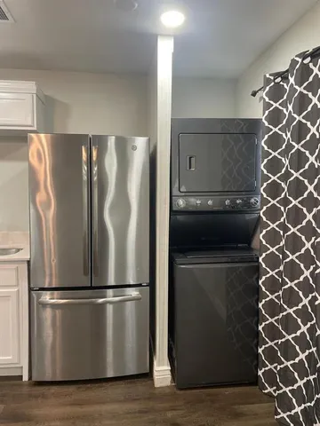 a metallic refrigerator freezer sitting in a kitchen