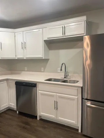 a kitchen with a sink and a refrigerator