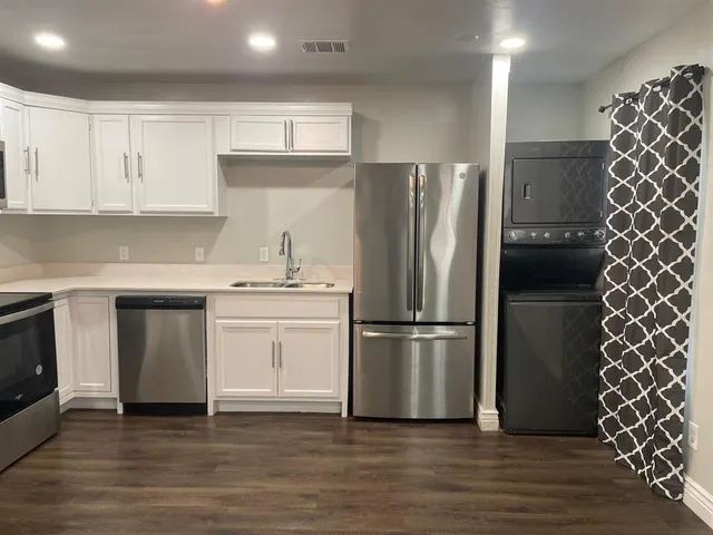 a kitchen with a refrigerator and a stove