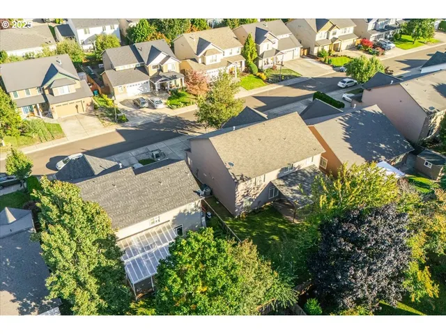 an aerial view of a house with a yard and lake view