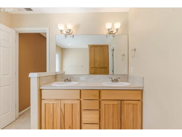 a bathroom with a granite countertop sink a large mirror and a
