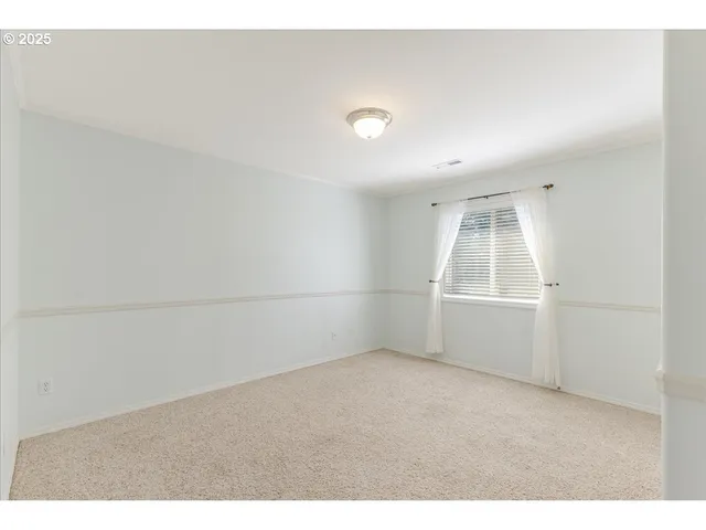 an empty room with a empty space and windows