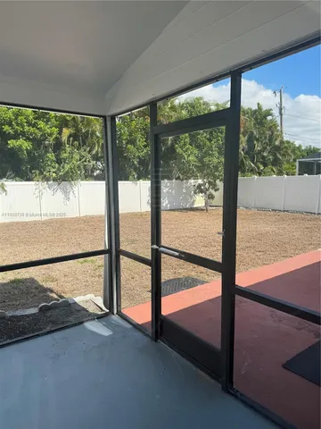 a view of a glass door and a yard from a window