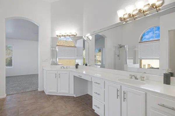 a bathroom with a double vanity sink mirror and
