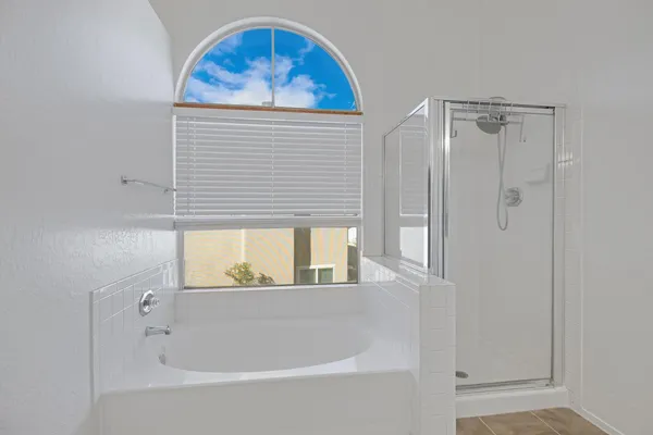 a bathroom with a bathtub and a shower