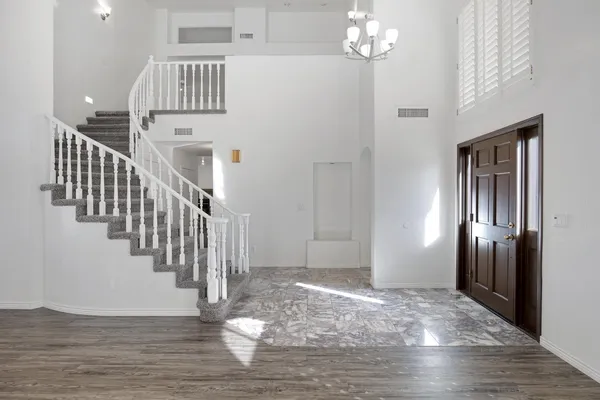 a view of entryway and hall with wooden floor