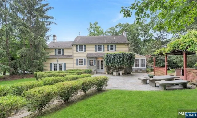 a view of a house with garden and sitting area