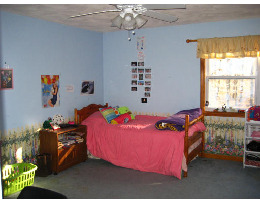 22 Albion Road Billerica, MA 01821 - Photo 11 of 26 a bedroom with a bed and a chandelier